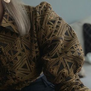 Black and copper bodysuit, bubble sleeve.